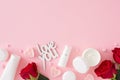 Flat lay photo of cosmetic bottles without label, red roses, heart shaped candles and inscription love you Royalty Free Stock Photo