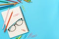 Flat lay photo of office desk with colorful pencil, Paper clip, Note book, Glasses, Top view of the copy space