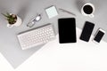 Flat lay photo of Office table with keyboard, notebook, digital tablet, mobile phone, Pencil, eyeglasses on modern two tone