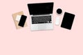 Flat lay photo of office table with laptop computer, digital tablet, mobile phone and accessories. on modern pink tone background. Royalty Free Stock Photo