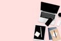 Flat lay photo of office table with laptop computer, digital tablet, mobile phone and accessories. on modern pink tone background. Royalty Free Stock Photo