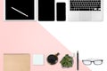 Flat lay photo of office table with laptop computer, digital tablet, mobile phone and accessories. on modern two tone white and p Royalty Free Stock Photo