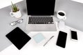 Flat lay photo of Office table with laptop computer, notebook, digital tablet, mobile phone on modern two tone background Royalty Free Stock Photo