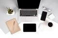 Flat lay photo of Office table with laptop computer, notebook, digital tablet, mobile phone on modern two tone background Royalty Free Stock Photo