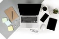 Flat lay photo of Office table with laptop computer, notebook, digital tablet, mobile phone on modern two tone background Royalty Free Stock Photo