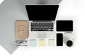 Flat lay photo of Office table with laptop computer, notebook, digital tablet, mobile phone on modern two tone background Royalty Free Stock Photo