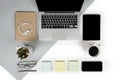 Flat lay photo of Office table with laptop computer, notebook, digital tablet, mobile phone on modern two tone background Royalty Free Stock Photo