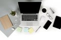 Flat lay photo of Office table with laptop computer, notebook, digital tablet, mobile phone on modern two tone background Royalty Free Stock Photo