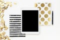 Flat lay photo of office white desk with tablet and gold notebook copy space background serpentine