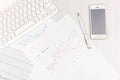 Flat lay photo of white office desk with laptop, smartphone, eyeglasses, notebook and pen with copy space background. Mockup