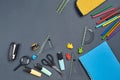 Flat lay photo of workspace desk with school accessories or office supplies on gray background. Royalty Free Stock Photo