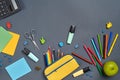 Flat lay photo of workspace desk with school accessories or office supplies on gray background. Royalty Free Stock Photo