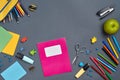 Flat lay photo of workspace desk with school accessories or office supplies on gray background. Royalty Free Stock Photo