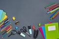 Flat lay photo of workspace desk with school accessories or office supplies on gray background. Royalty Free Stock Photo