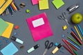 Flat lay photo of workspace desk with school accessories or office supplies on gray background. Royalty Free Stock Photo