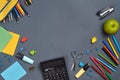 Flat lay photo of workspace desk with school accessories or office supplies on gray background. Royalty Free Stock Photo