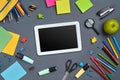 Flat lay photo of workspace desk with school accessories or office supplies on gray background. Royalty Free Stock Photo