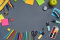 Flat lay photo of workspace desk with school accessories or office supplies on gray background. Royalty Free Stock Photo