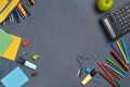 Flat lay photo of workspace desk with school accessories or office supplies on gray background. Royalty Free Stock Photo