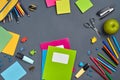 Flat lay photo of workspace desk with school accessories or office supplies on gray background. Royalty Free Stock Photo