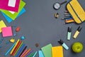 Flat lay photo of workspace desk with school accessories or office supplies on gray background. Royalty Free Stock Photo