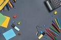 Flat lay photo of workspace desk with school accessories or office supplies on gray background. Royalty Free Stock Photo