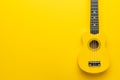 Flat lay photo of yellow ukulele with copy space Royalty Free Stock Photo