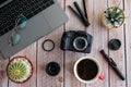 Flat lay of photography equipment on wooden desktop background: dslr camera, laptop and lens. Blogger workspace concept. Top view Royalty Free Stock Photo