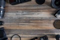 Flat lay of photography equipment on wooden desktop background: dslr camera and lens. Photographer workspace concept. Copy space,