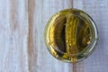 Flat lay of a pickled cucumbers in a glass container