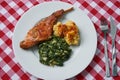 Flat lay picture of roasted rabbit leg, marinated in garlic and rosemary served with spinach and potato dumplings Royalty Free Stock Photo