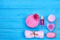 Flat lay pink accessories for bath and spa on blue wood. Royalty Free Stock Photo