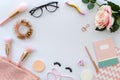 Flat lay pink composition with copy space, blank note, cosmetics, makeup tools, glasses and rose on white background Royalty Free Stock Photo