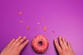 Hands next to donut with space for text Royalty Free Stock Photo