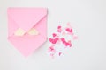 Flat lay: pink hand made envelope, confetti hearts, origami yellow heart made of paper for notes. Making postcard for Valentine`s