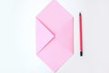 Flat lay: pink paper folded in the shape of envelop, pencil. Making a postcard in an envelope for Valentine`s Day. Do it yourself