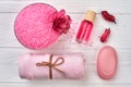 Flat lay pink spa accessories on white wooden desk. Royalty Free Stock Photo