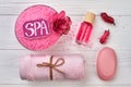 Flat lay pink spa accessories on white wooden desk. Royalty Free Stock Photo