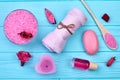 Flat lay pink spa treatment accessories on blue wood. Royalty Free Stock Photo