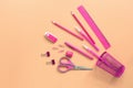 Flat lay pink stationery on a pastel background. Top view, copy space. Glass, scissors, pencil, pen, ruler, eraser and paper clip Royalty Free Stock Photo