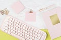 Flat lay pink stationery on work desk