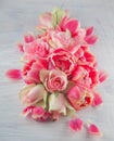 Flat lay with pink tulips and roses blossom flowers over white wood background, top view. Royalty Free Stock Photo