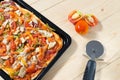 Flat lay pizza composition, tomatoes on wooden surface, close up macro