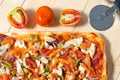 Flat lay pizza composition, tomatoes on wooden surface, close up macro