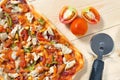 Flat lay pizza composition, tomatoes on wooden surface, close up macro