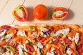 Flat lay pizza composition, tomatoes on wooden surface, close up macro