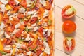 Flat lay pizza composition, tomatoes on wooden surface, close up macro