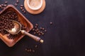 Flat lay with place for text. Hot cup of coffee and plate with coffee beans on black wooden table