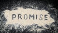 Flat lay of PROMISE word written on white sand Royalty Free Stock Photo