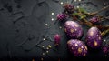 flat lay purple Easter eggs with gold decoration and floral branches on dark background. free space Royalty Free Stock Photo